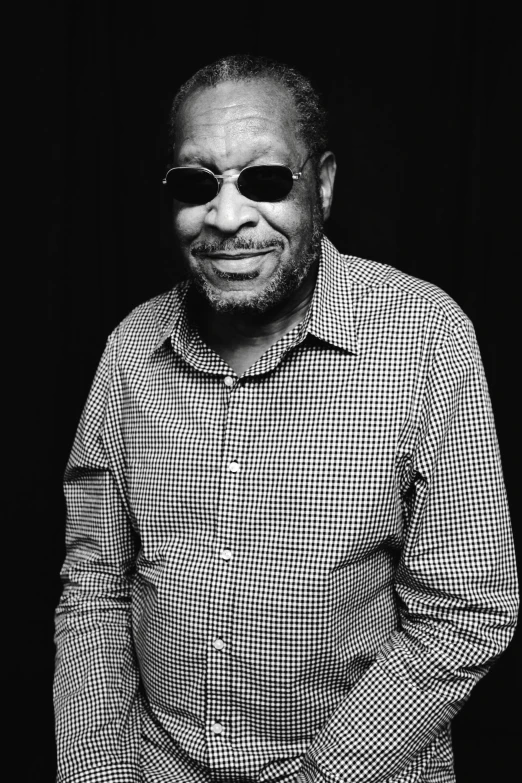 a black and white photo of a man wearing sunglasses, by Charles Ellison, george clinton, while smiling for a photograph, medium format. soft light, cane