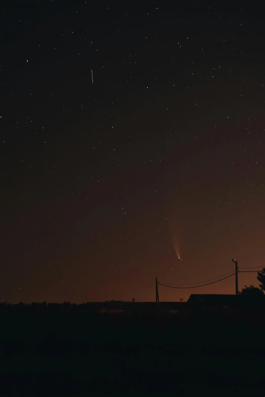 an airplane flying over a city at night, by Attila Meszlenyi, comets, side view from afar, 2019 trending photo, angel falling to andromeda