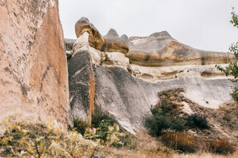 a large rock formation in the middle of a field, trending on pexels, art nouveau, located in hajibektash complex, profile image, ocher details, instagram photo