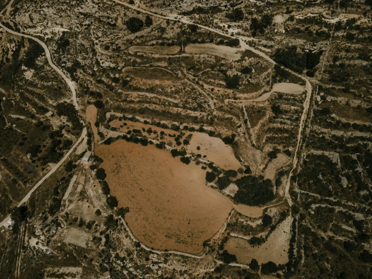 an aerial view of a field and a lake, pexels contest winner, cyprus, detailed terrain texture, thumbnail, low-key