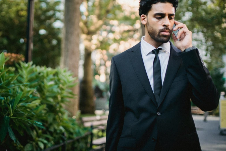 a man in a suit talking on a cell phone, pexels contest winner, realism, riyahd cassiem, girl in suit, al fresco, black tie