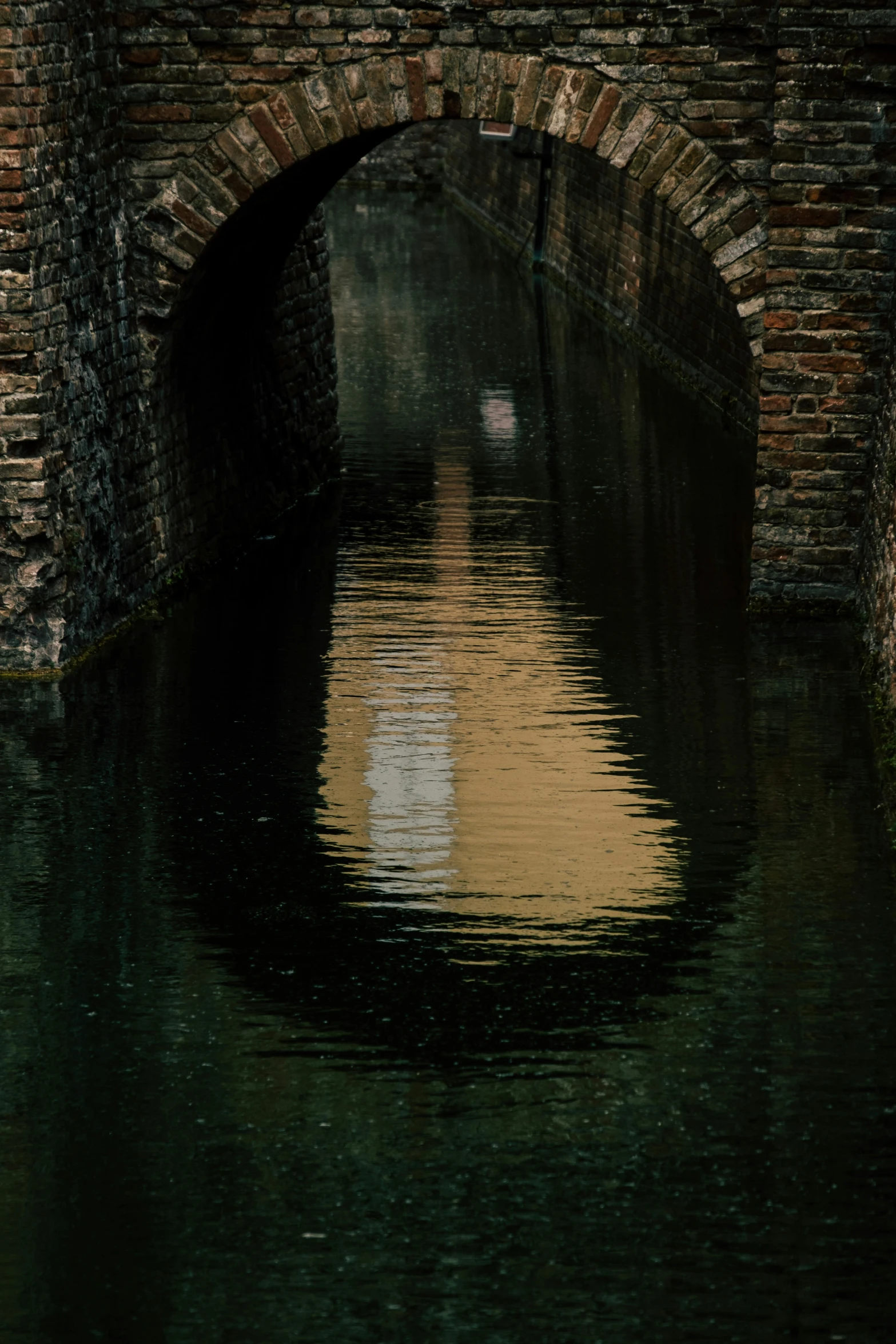 a bridge over a body of water with a building in the background, by Jan Tengnagel, pexels contest winner, tonalism, high walled tunnel, vhs colour photography, delft, water ripples