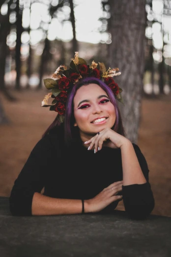a woman with purple hair and a wreath on her head, a colorized photo, by Robbie Trevino, pexels contest winner, smiling young woman, 🍂 cute, black and red tones, hair made of trees