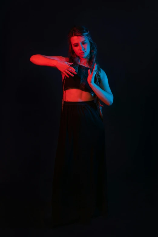 a woman in a black dress holding a red light, by Alexis Grimou, art photography, wearing a black cropped tank top, dance, medium portrait top light, red and blue black light