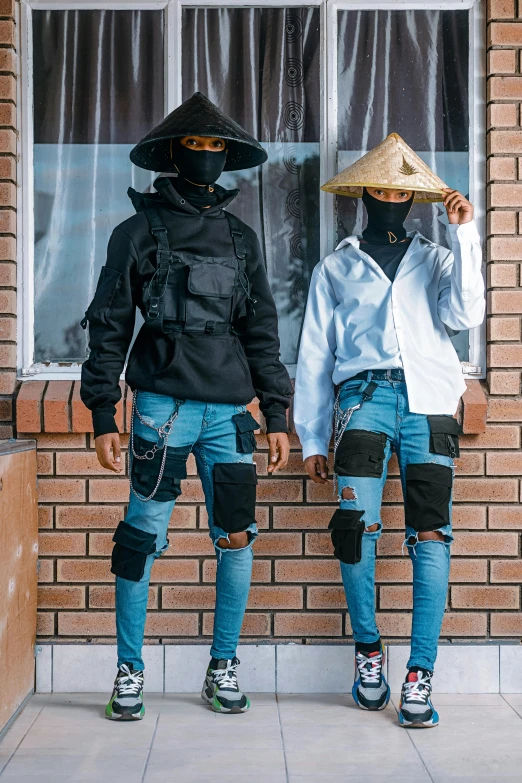 two people standing in front of a brick building, unsplash, afrofuturism, ripped jeans, balaclava, wearing farm clothes, flat lay