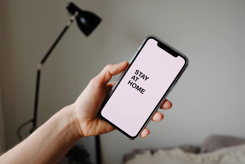 a person holding a cell phone in their hand, trending on pexels, pink and black, home display, slay, background image