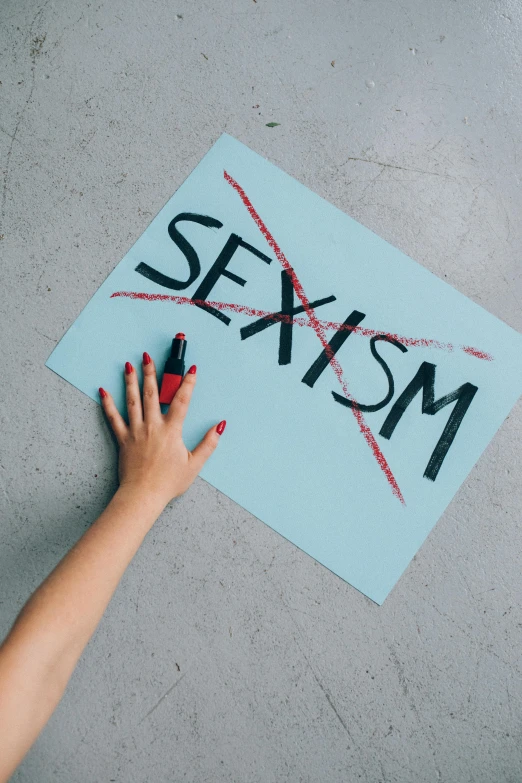 a person holding a sign that says sex, a poster, trending on pexels, feminist art, flatlay, asylum, background image, splash image