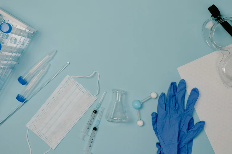 medical equipment laid out on a blue surface, pexels contest winner, plasticien, blue gloves, background image, syringe, album