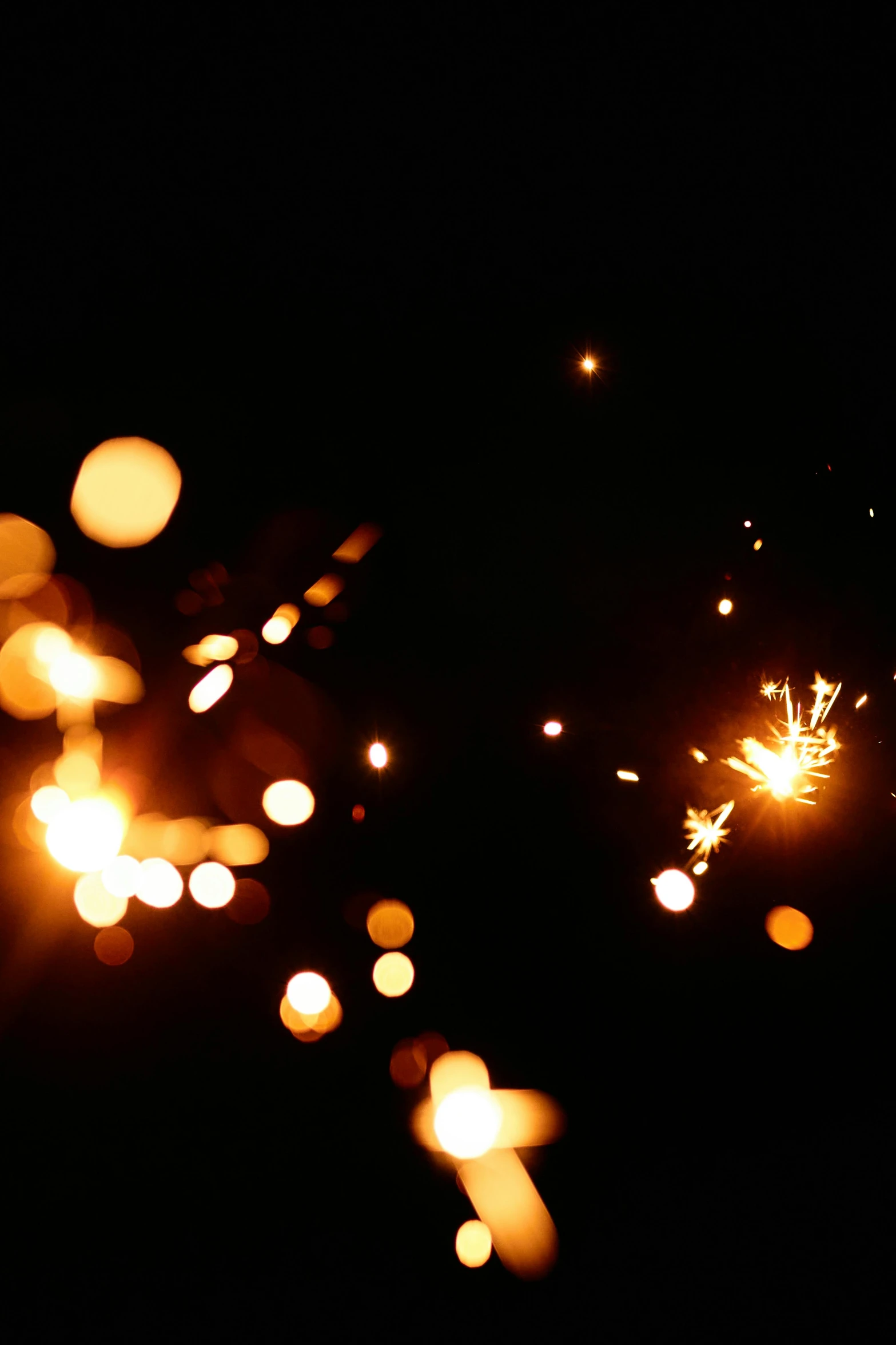 a close up of sparklers in the dark, light and space, emitting light ornaments, cinematic shot ar 9:16 -n 6 -g, medium-shot