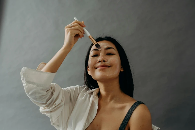 a woman holding a pair of chopsticks up to her face, a hyperrealistic painting, trending on pexels, happening, clean face and body skin, textured base ; product photos, woman is curved, with axe