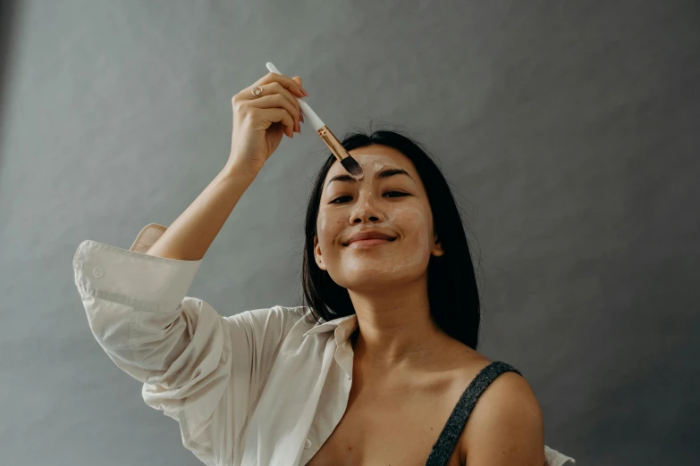 a woman holding a pair of chopsticks up to her face, a hyperrealistic painting, trending on pexels, happening, clean face and body skin, textured base ; product photos, woman is curved, with axe