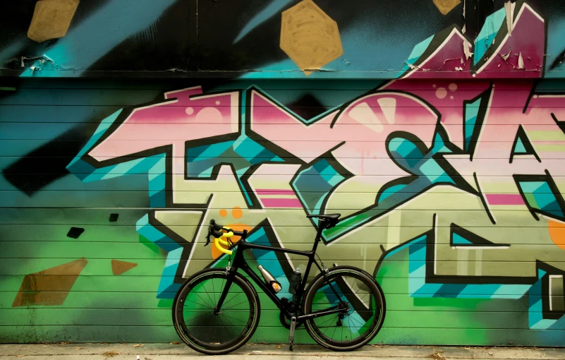 a bicycle parked in front of a graffiti covered wall, pexels contest winner, graffiti, turbo, campy and colorful, instagram post, profile image