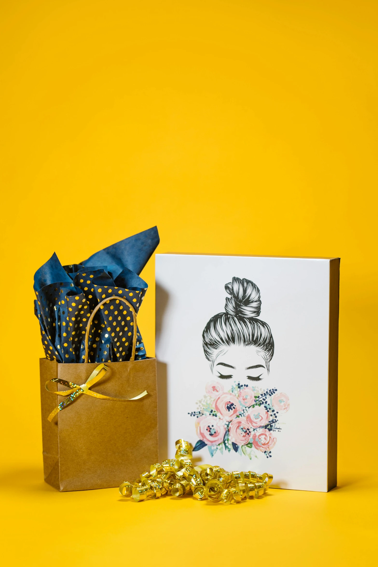 a card with a picture of a woman's face on it next to a gift bag, a portrait, gold flowers, 1 6 x 1 6, bashful, blue theme and yellow accents