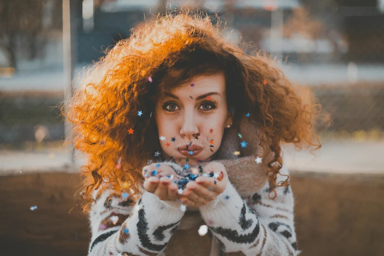 a woman blowing confetti in front of her face, pexels contest winner, pointillism, red curly hair, winter vibes, cute girls, brown fluffy hair