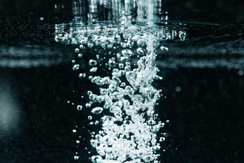 a close up of water with bubbles coming out of it, dark blue water, swimming to surface, water pipe, promo image