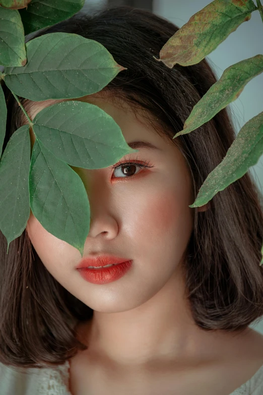 a close up of a woman with a leaf on her head, a colorized photo, inspired by Jung Park, trending on pexels, young cute wan asian face, coral lipstick, with soft bushes, photo - realistic )