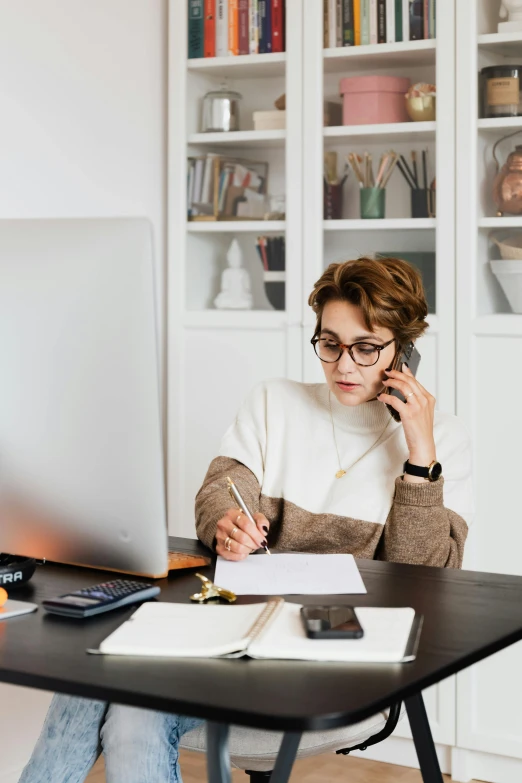 a woman sitting at a desk talking on a cell phone, trending on pexels, floating monitors, writing a letter, low quality photo, wealthy women