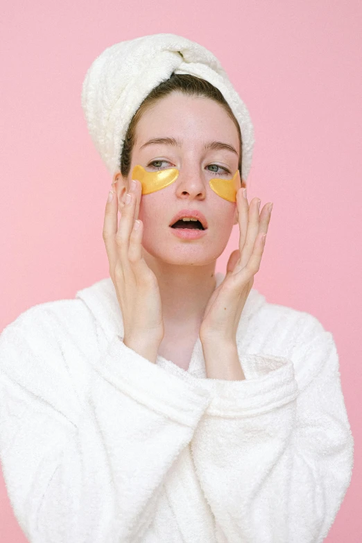 a woman with an orange peel on her face, an album cover, trending on pexels, pink and yellow, black eye mask, spa, tired expression