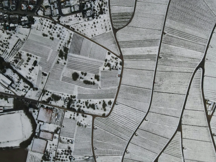 a black and white photo of a snow covered landscape, a detailed painting, by Carey Morris, unsplash contest winner, conceptual art, isometric aerial view, rows of lush crops, villages, color aerial photo drone