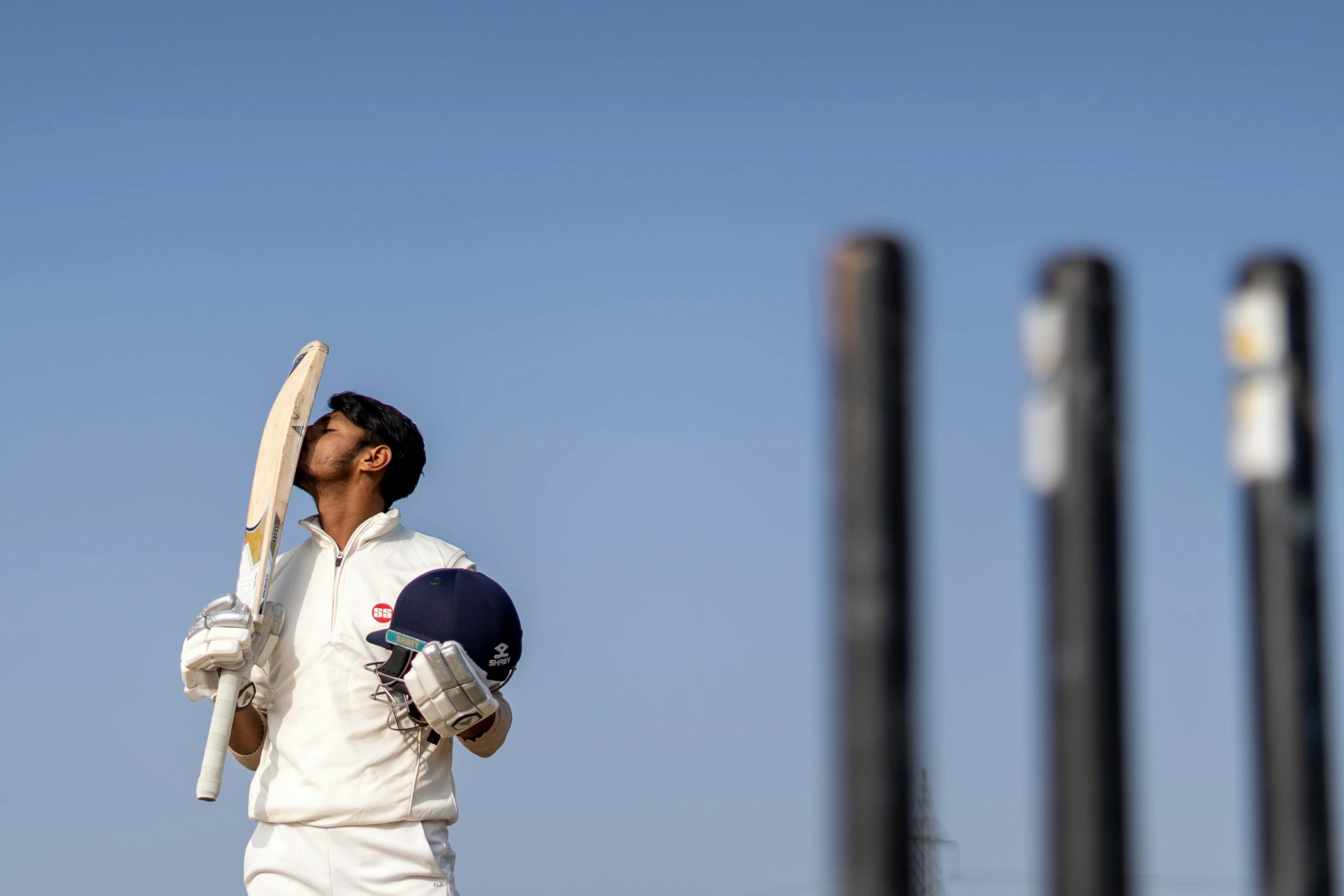 a man holding a bat on top of a field, a portrait, inspired by Mitchell Johnson, pexels contest winner, triumphant pose, white, kyza saleem, mechanised