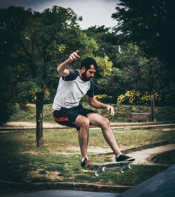 a man flying through the air while riding a skateboard, by Luis Molinari, pexels contest winner, realism, at a park, young man with short, gif, bench