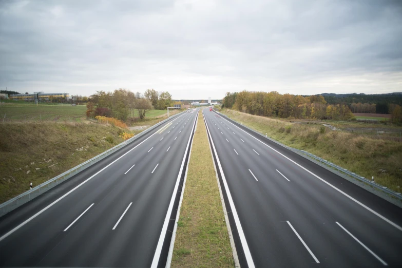 a highway with two lanes in the middle of it, by Adam Szentpétery, unsplash, hyperrealism, germany. wide shot, construction, 15081959 21121991 01012000 4k, less detailing