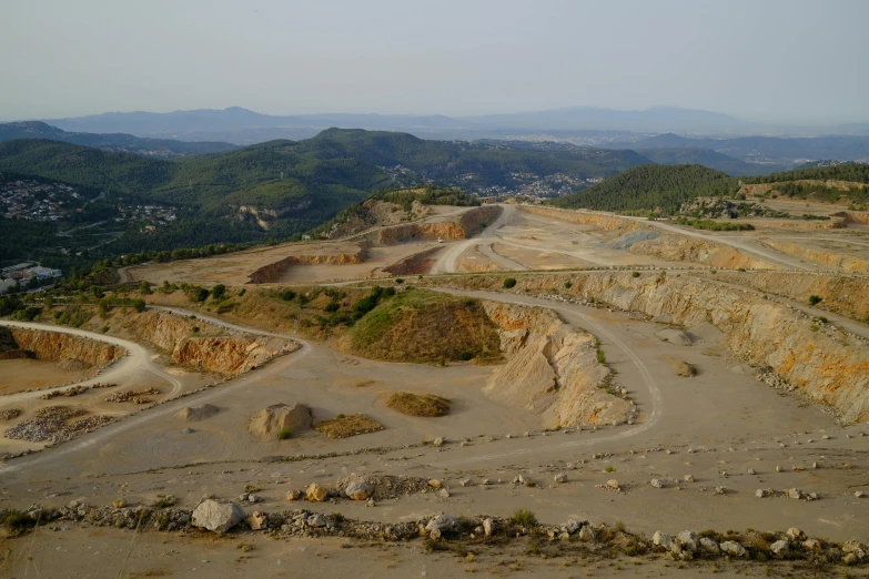 a large open pit filled with lots of dirt, a portrait, flickr, les nabis, ibiza, promo image, sloped site, university