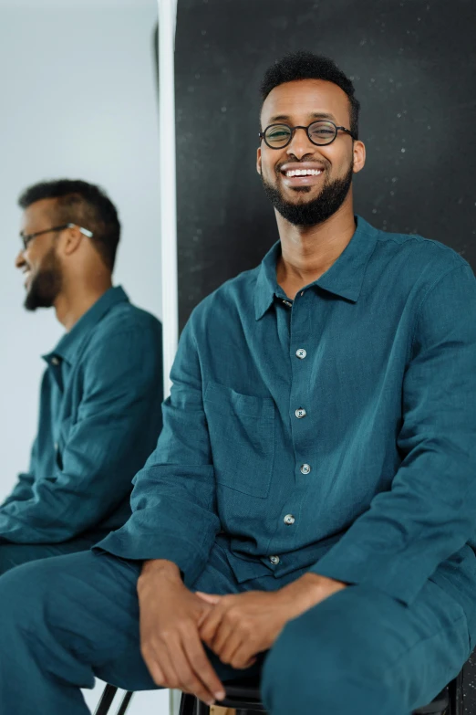 two men sitting next to each other in front of a mirror, inspired by Ismail Gulgee, trending on unsplash, renaissance, teal uniform, wearing pajamas, portrait of tall, wearing a linen shirt