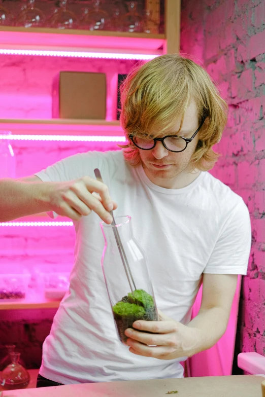 a man pouring a drink into a glass, inspired by Gordon Browne, featured on reddit, process art, terrarium lounge area, blonde guy, herbs, ed sheeran