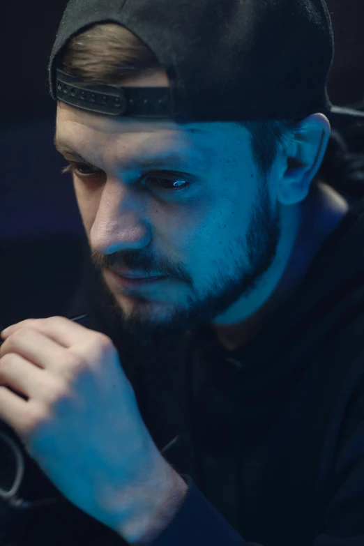 a man holding a video game controller in his hand, a character portrait, trending on reddit, hyperrealism, still from a music video, serious sad look in his eyes, demna gvasalia, dramatic lighting; 4k 8k