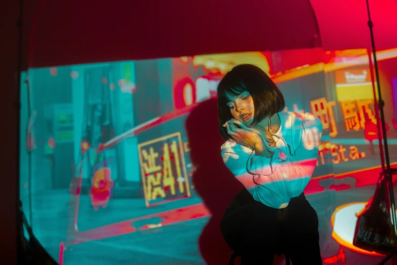 a woman standing under an umbrella in a dark room, inspired by Liam Wong, hyperrealism, reflected in giant mirror, colorful projections, performing a music video, red and cyan