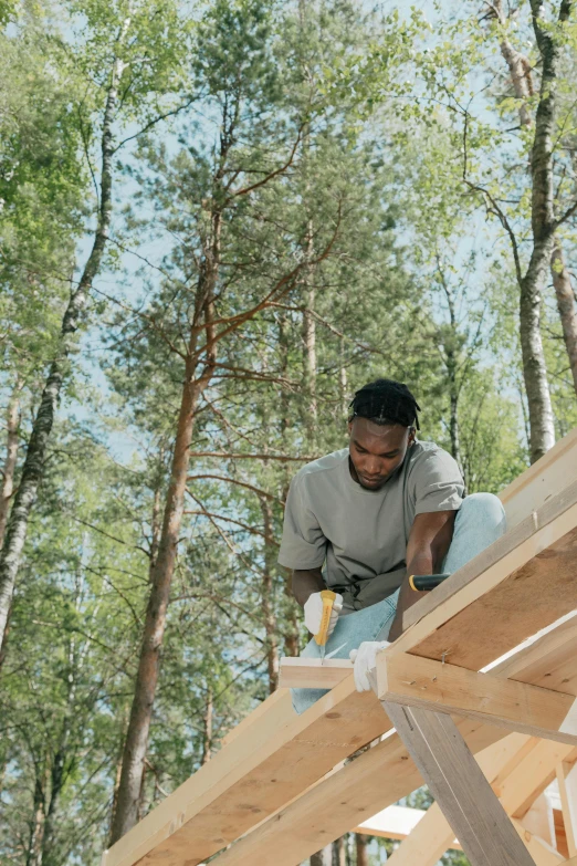 a man working on a wooden structure in the woods, : kendrick lamar, rounded roof, thumbnail, profile image