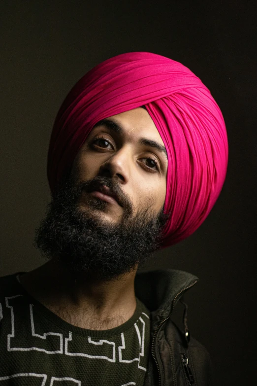 a man with a pink turban on his head, an album cover, trending on pexels, lgbtq, indian super model, in 2 0 1 5, proud serious expression