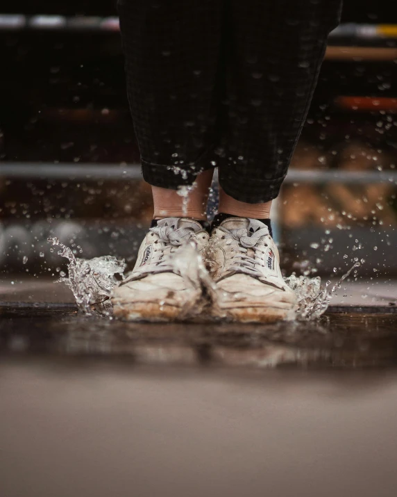 a person standing in a puddle of water, wearing white sneakers, lgbtq, splash image, multiple stories