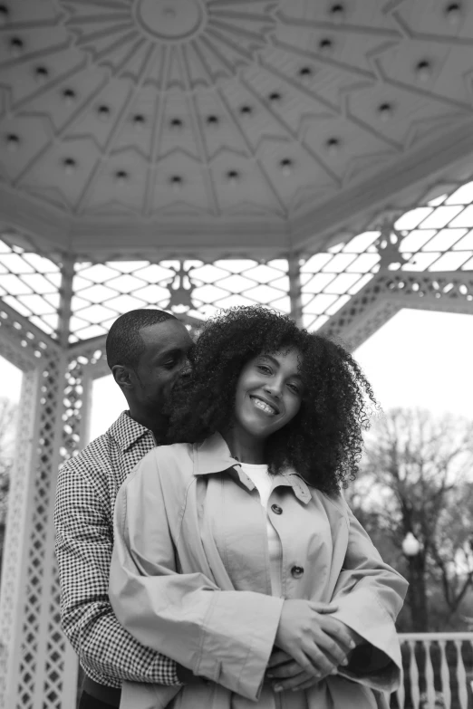 a man standing next to a woman under a gazebo, a black and white photo, pexels contest winner, harlem renaissance, curls on top, sza, they are in love, parks