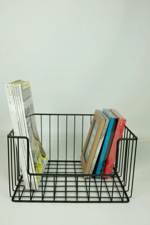 a wire basket filled with books on top of a table, an album cover, rack, product view, small, 8l