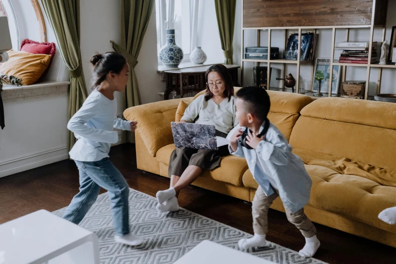 a group of children playing a video game in a living room, pexels contest winner, interactive art, dancing character, husband wife and son, nivanh chanthara, fighting each other