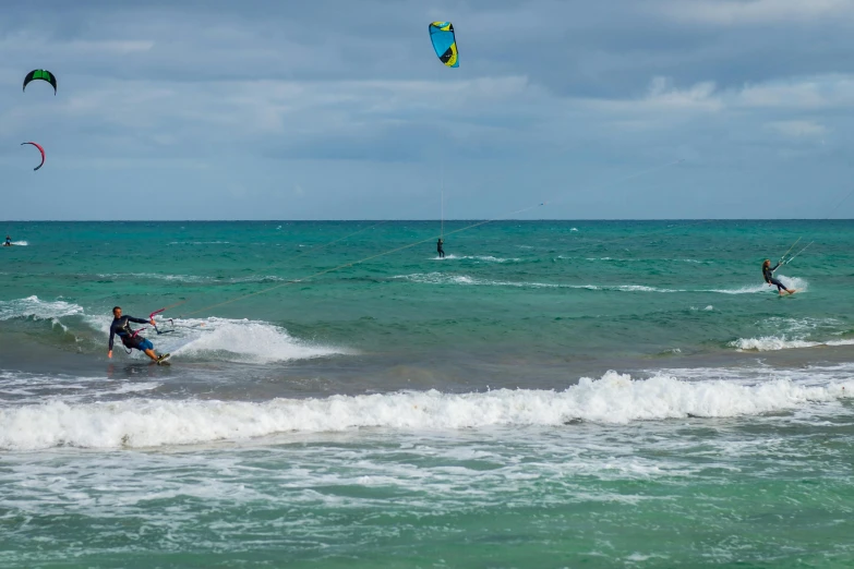 a group of people windsurfing in the ocean, astri lohne, south beach colors, australian beach, view of the ocean