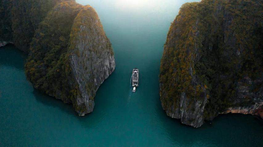a boat in the middle of a large body of water, by Raymond Han, pexels contest winner, vietnam, chasm, beeple style, 8 k 4 k