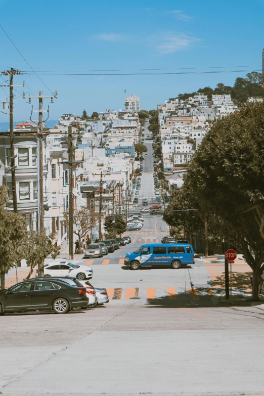 a couple of cars parked on the side of a road, by Carey Morris, unsplash contest winner, renaissance, photograph of san francisco, be running up that hill, street of teal stone, from a distance