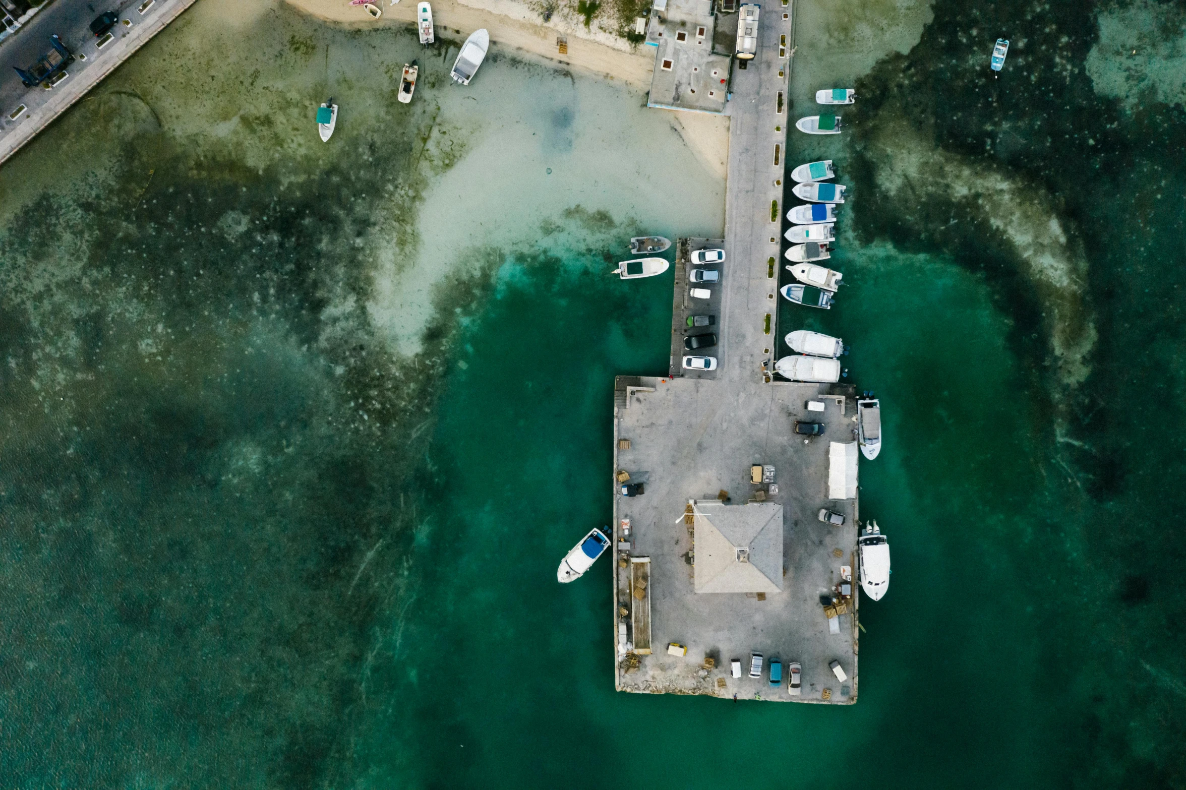 a group of boats sitting on top of a body of water, a screenshot, by Carey Morris, pexels contest winner, near a jetty, birdeye, jamaica, thumbnail
