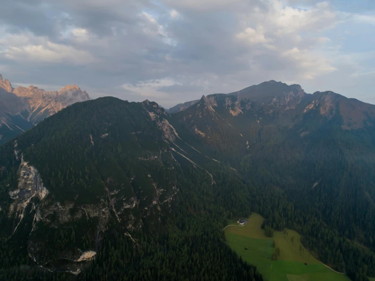 a view of the mountains from the top of a mountain, by Sebastian Spreng, pexels contest winner, aerial shot from the drone, summer evening, dolomites, slight overcast lighting