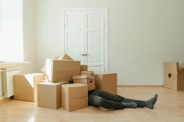 a man laying on the floor surrounded by boxes, temporary art, cursed imagery, without text, covid, danbooru