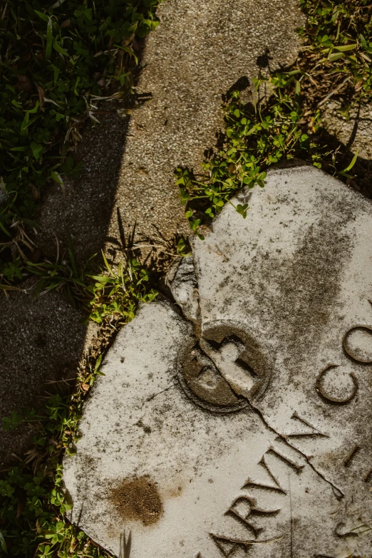 a grave marker sitting on the side of a road, unsplash, concrete art, close-up from above, historical, ron cobb, shot on sony a 7 iii