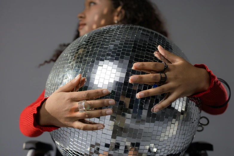 a close up of a person holding a disco ball, lizzo, hand model, hands shielding face, woman holding another woman