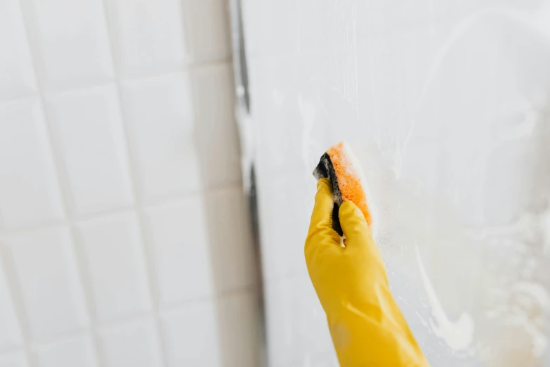 a person in yellow rubber gloves cleaning a shower, by Julia Pishtar, unsplash, on a pale background, profile image, brushed, upscaled to high resolution