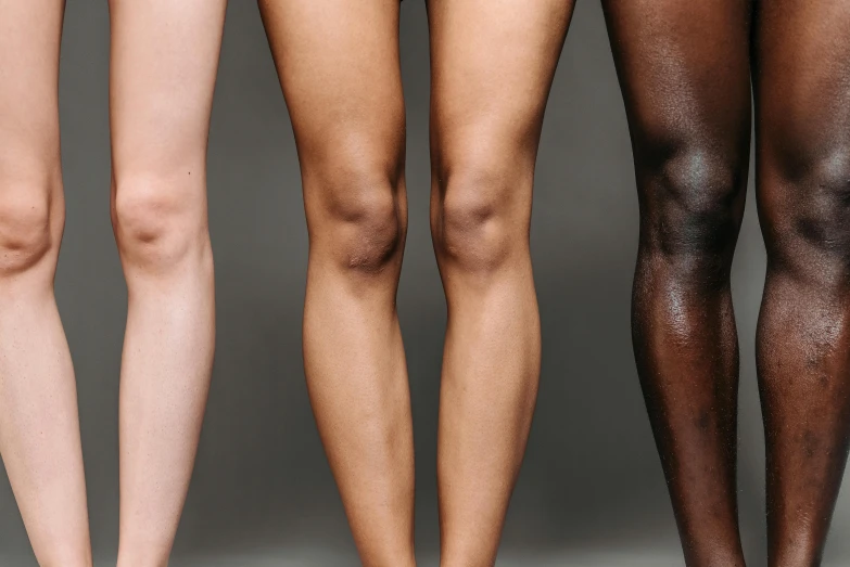 a group of women standing next to each other, by Carey Morris, trending on pexels, antipodeans, thigh skin, with brown skin, gradient brown to silver, vastus lateralis