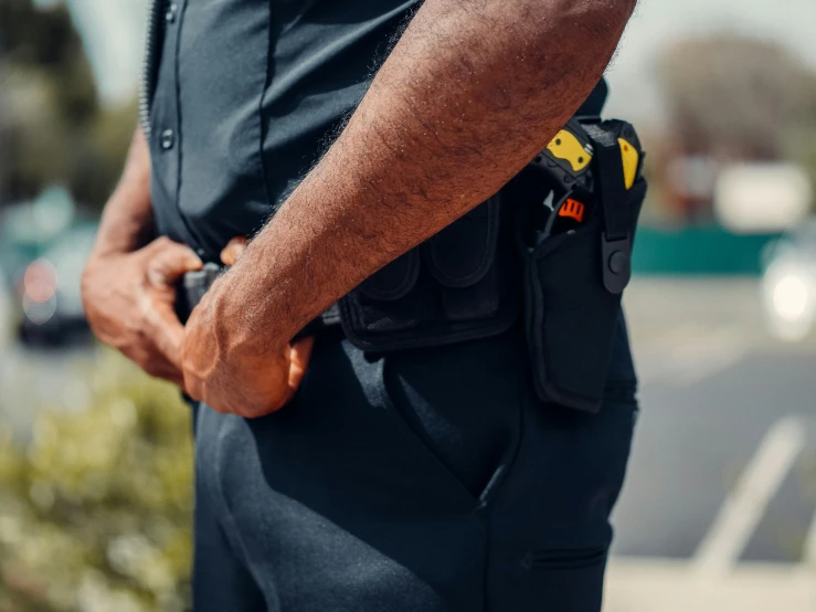 a police officer standing on the side of the road, pexels, with two front pockets, navy, 3 - piece, high quality product image”