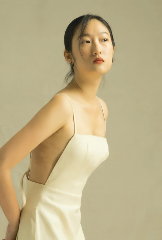 a woman in a white dress posing for a picture, inspired by Gao Cen, unsplash, wearing a camisole, jinyoung shin, gown, sleek