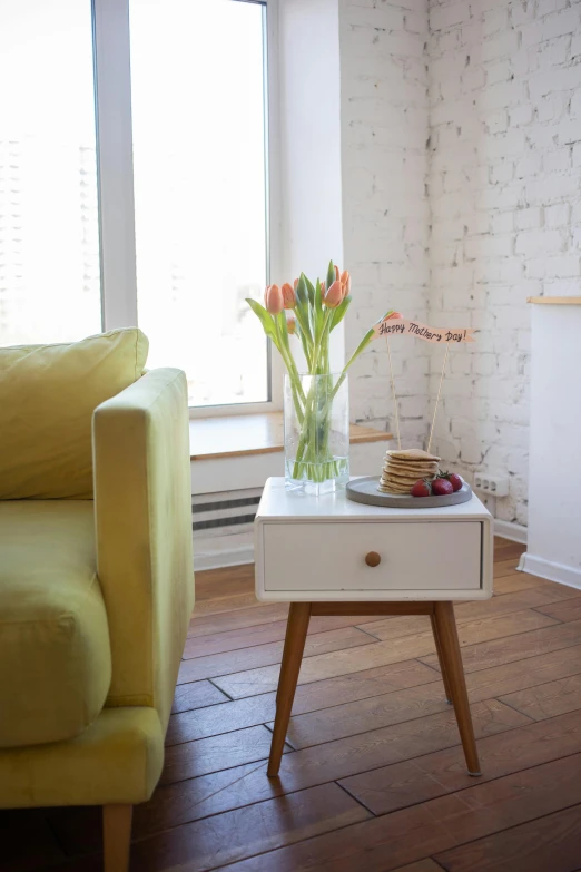 a living room filled with furniture and a fire place, inspired by Constantin Hansen, pexels contest winner, light and space, chrysanthemum and tulips, wooden side table, city morning, square